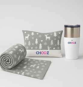 A pampering gift set for employees – includes a cozy blanket, a heating pad, and a thermal mug